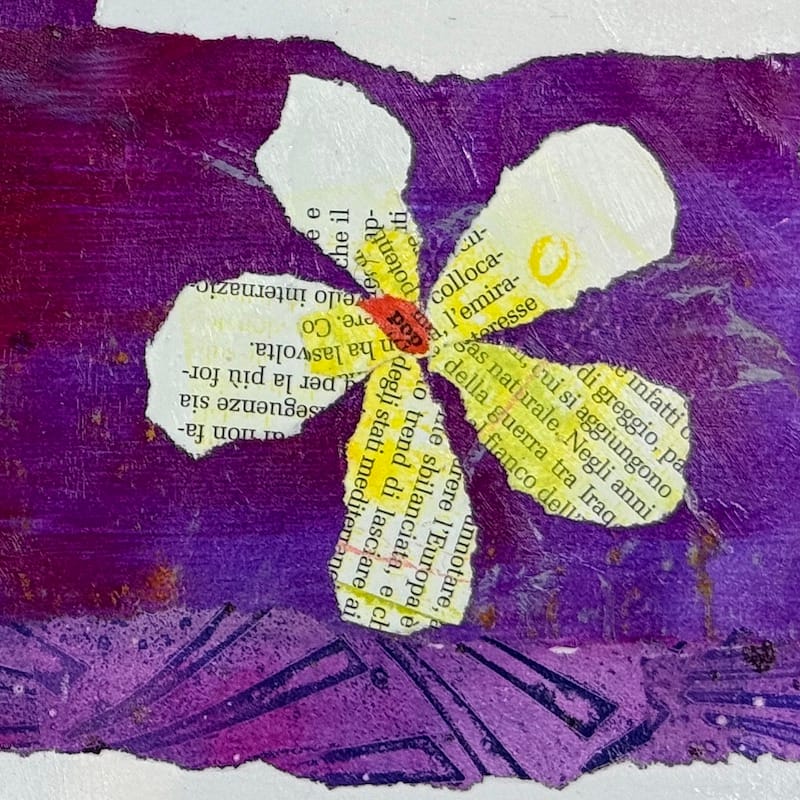 A single collaged flower made with paper from a magazine. Words radiate from the centre. In the centre is a piece of torn text saying 'pop'