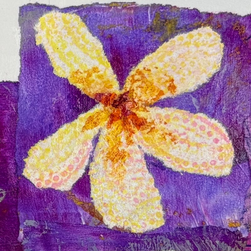 A single collaged flower made with patterned hand printed paper.