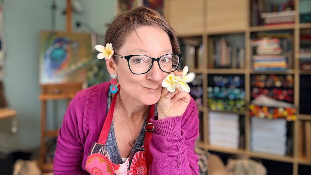 Photo of Amber Bennison with a Frangipani/Plumeria flower