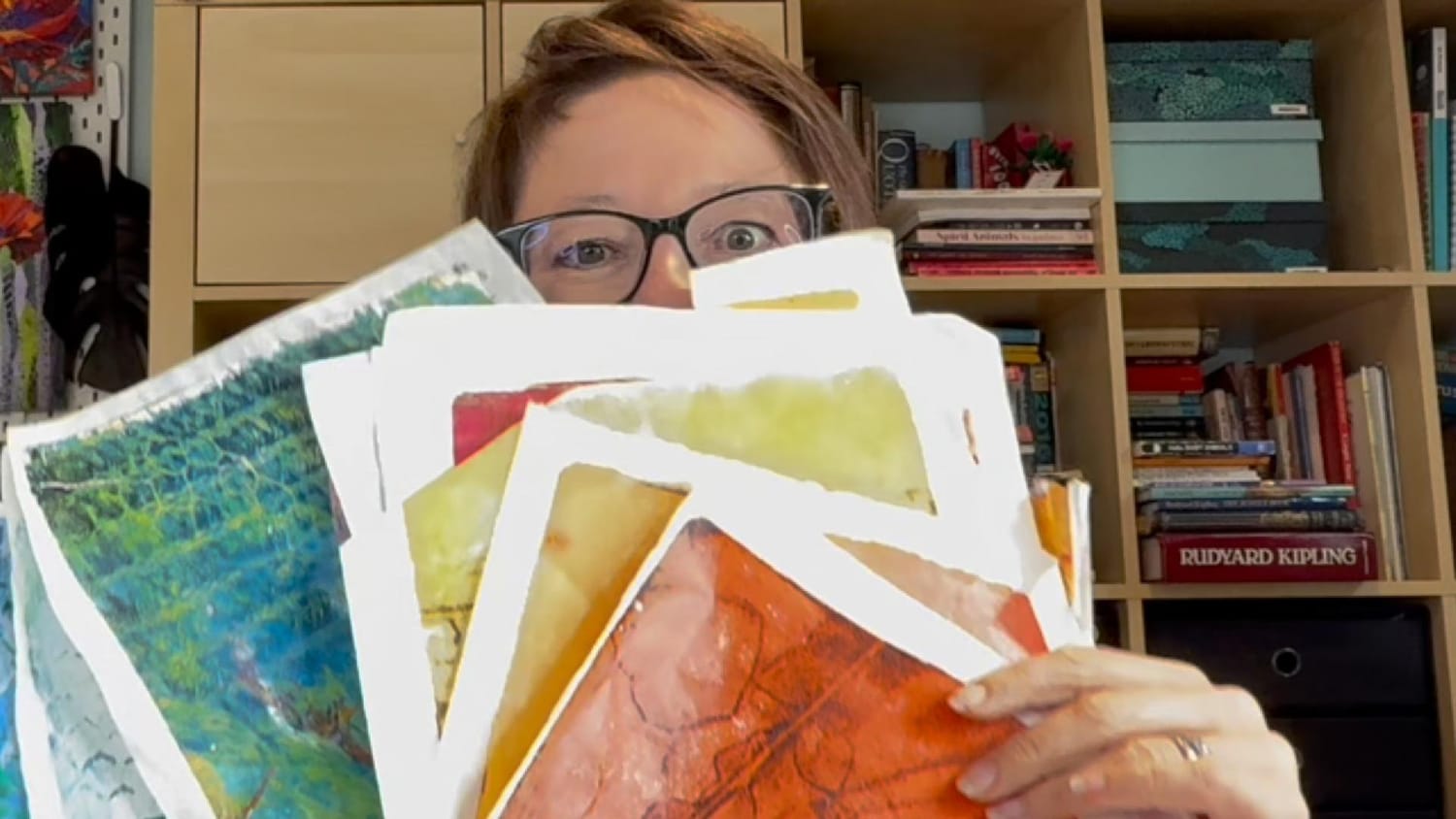 Photo of Amber Bennison with gel prints and collage papers