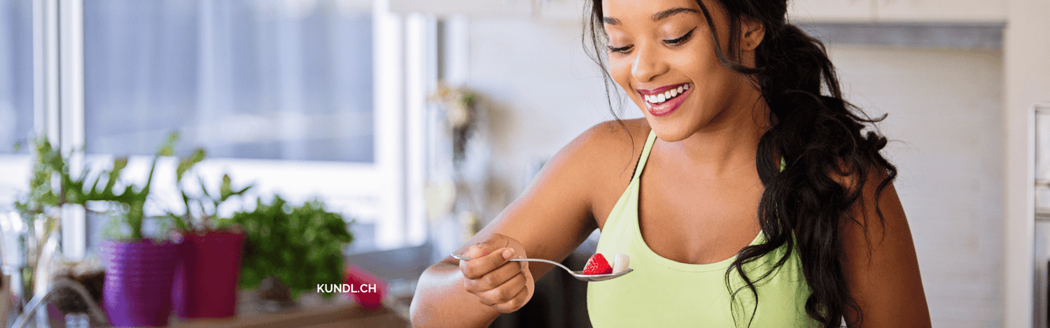 lachende Frau die Obst ist