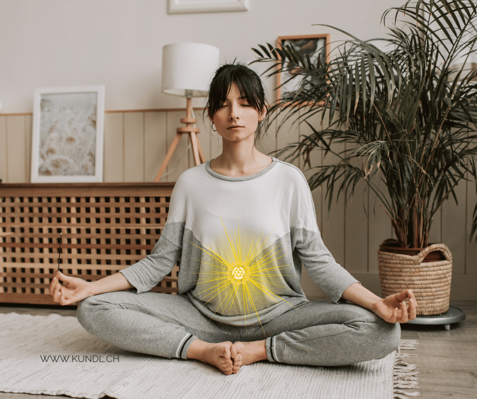 Frau die sich eine Meditation auf ihr Nabelchakra zuhause schenkt