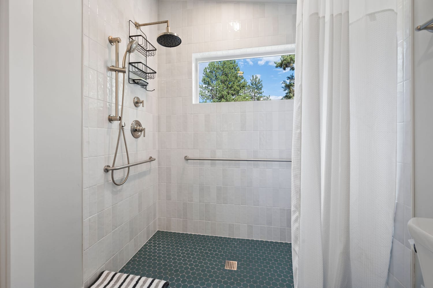 Accessible bathroom with a curbless-style shower and grab bars