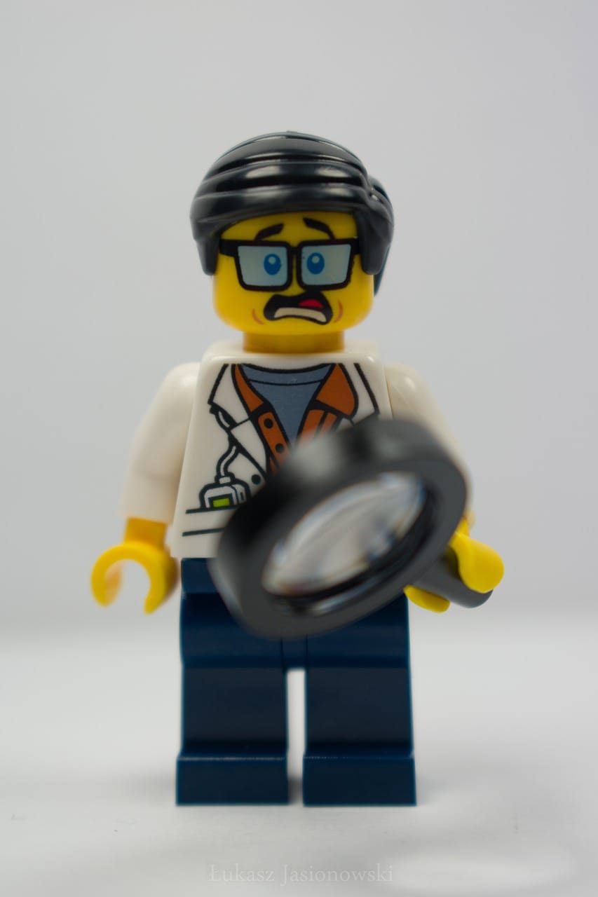 Curios LEGO minifigure with a magnifying glass