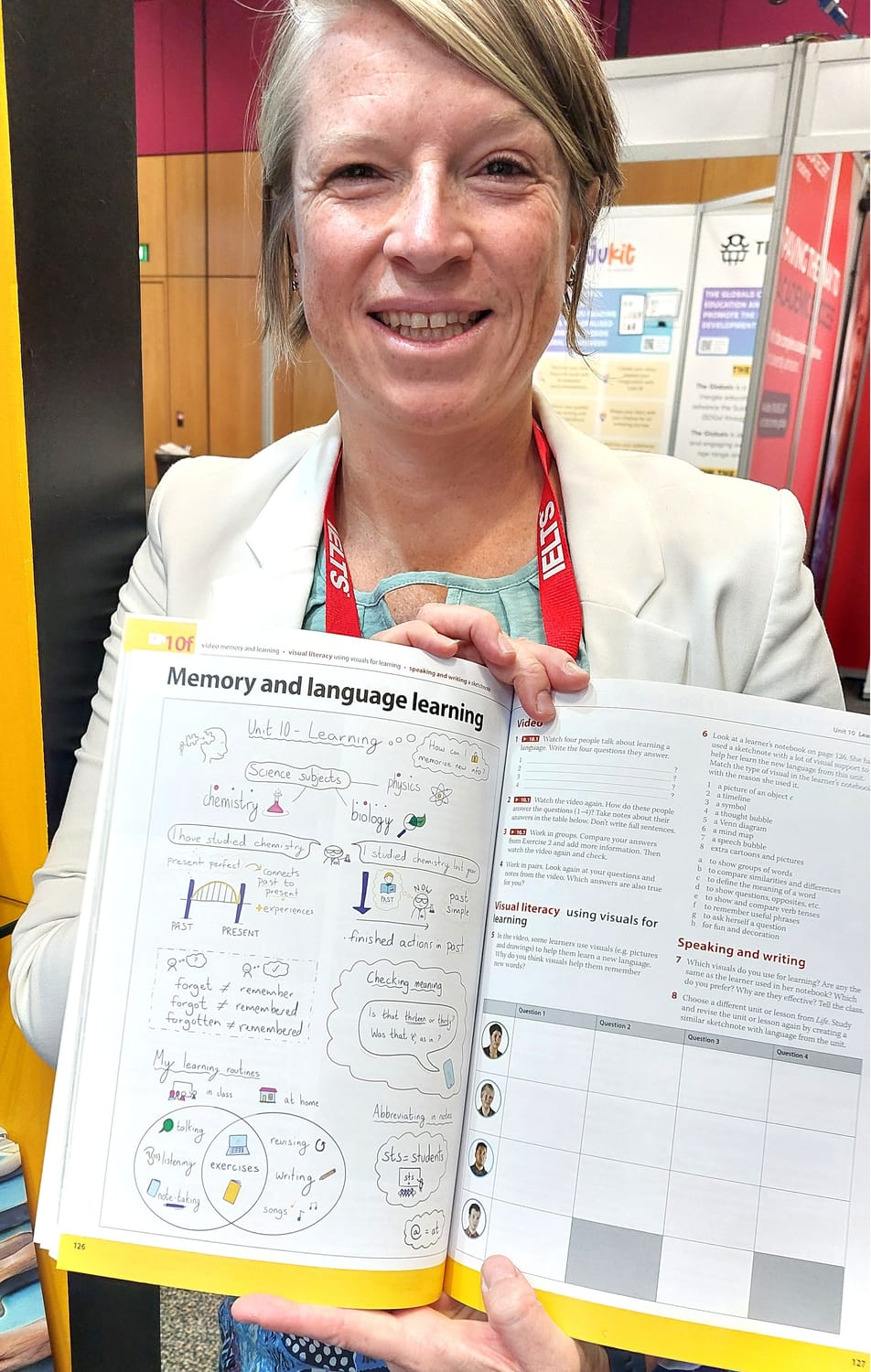 Emily Bryson holding a copy of Life Elementary by National Geographic Learning. The English language teaching coursebook is open on a page with a sketchnote entitled 'Memory and language learning'