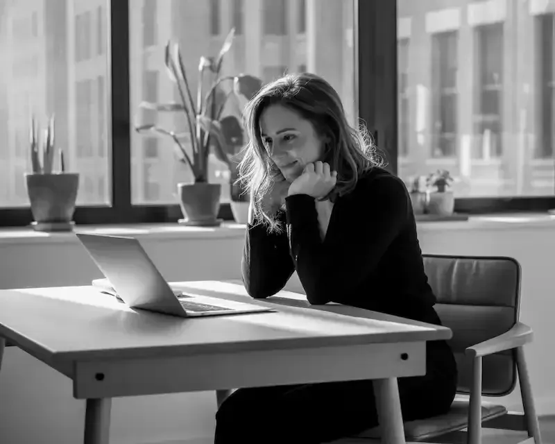 Femme blogueuse rédigeant son avis sur les formations de Nina Habault dans un café à Montréal.