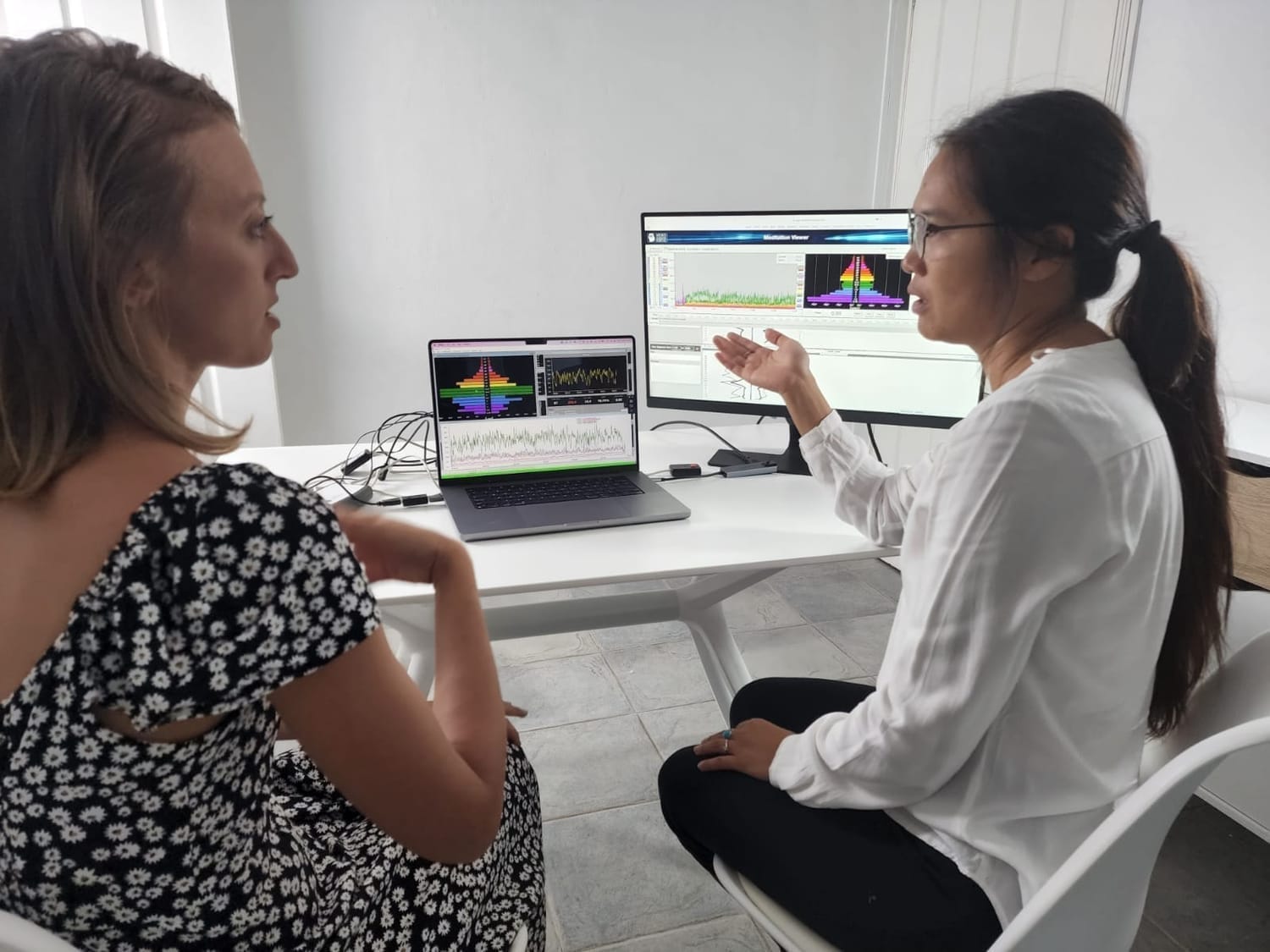 Lila Devane guiding a client through EEG brainwave coaching session for alignment and emotional regulation.