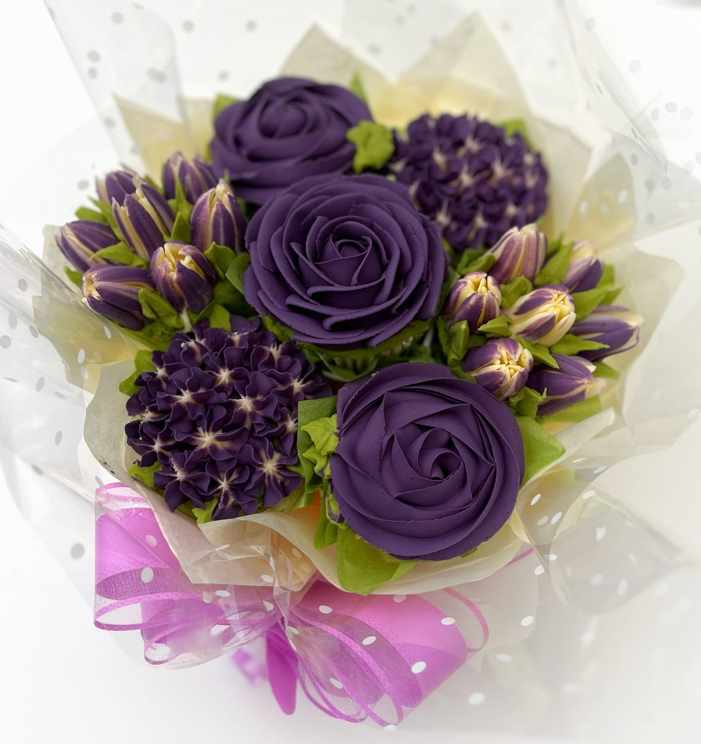 Purple cupcake bouquet with buttercream roses and tulips – created by Sharon Burchall Cake Studio