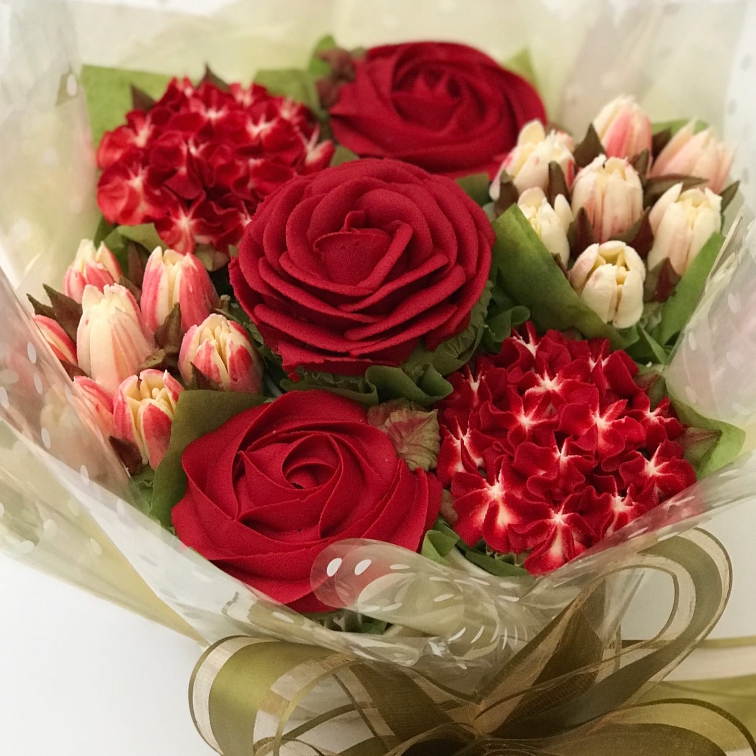 Red cupcake bouquet with buttercream roses, hydrangeas and tulips – created by Sharon Burchall Cake Studio