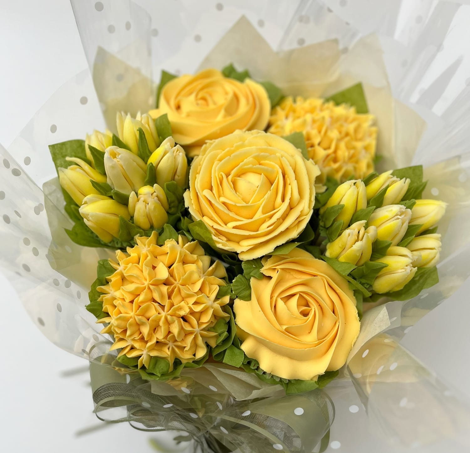 Lemon yellow cupcake bouquet with buttercream roses, hydrangeas and tulips – created by Sharon Burchall Cake Studio