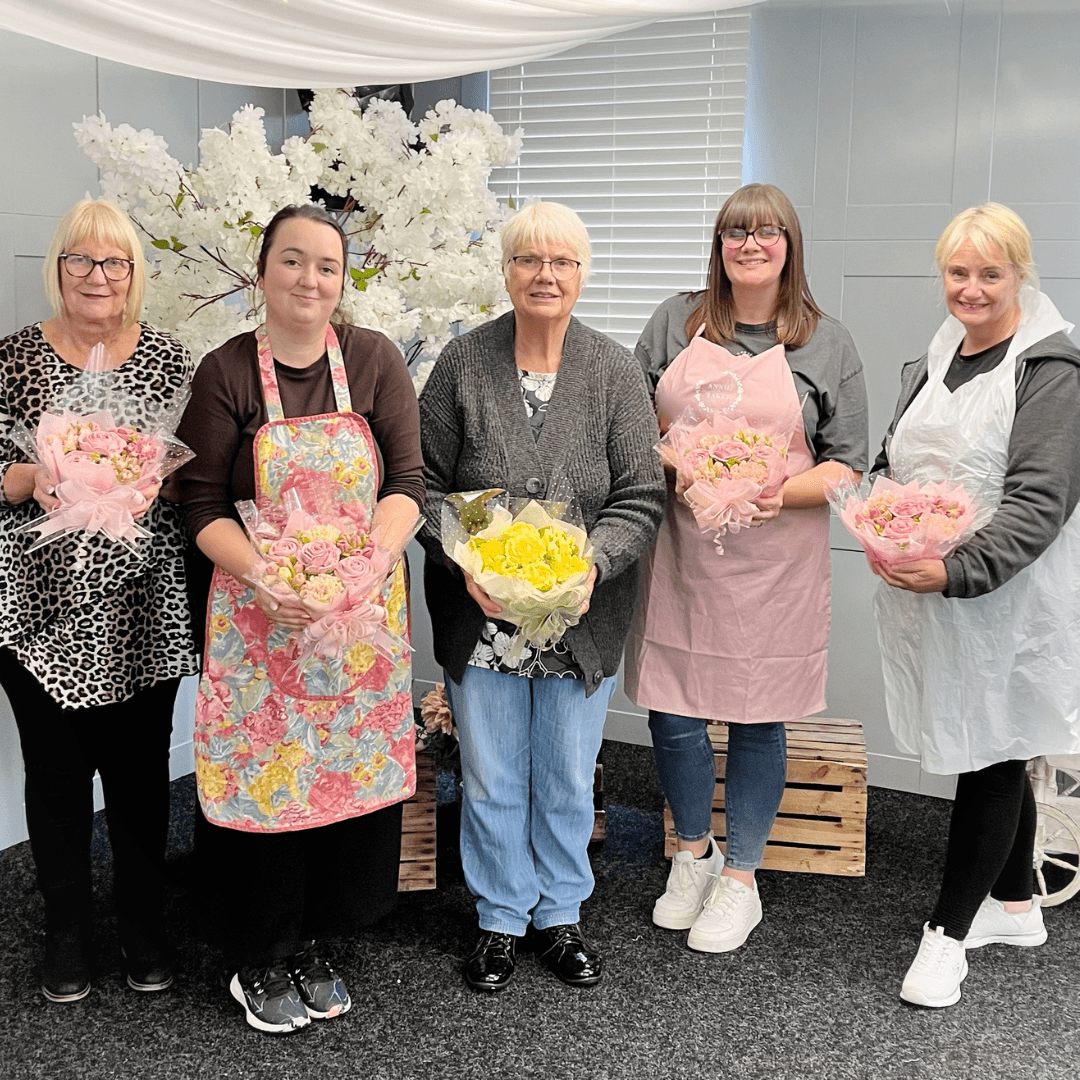 Students proudly holding their finished cupcake bouquets after a Beginners Cupcake Bouquet Class with Sharon Burchall Cake Studio