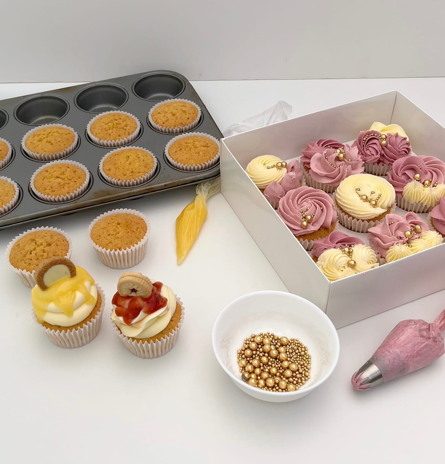 Cupcake and Buttercream Masterclass setup with cupcakes, buttercream, and piping tools at Sharon Burchall Cake Studio.