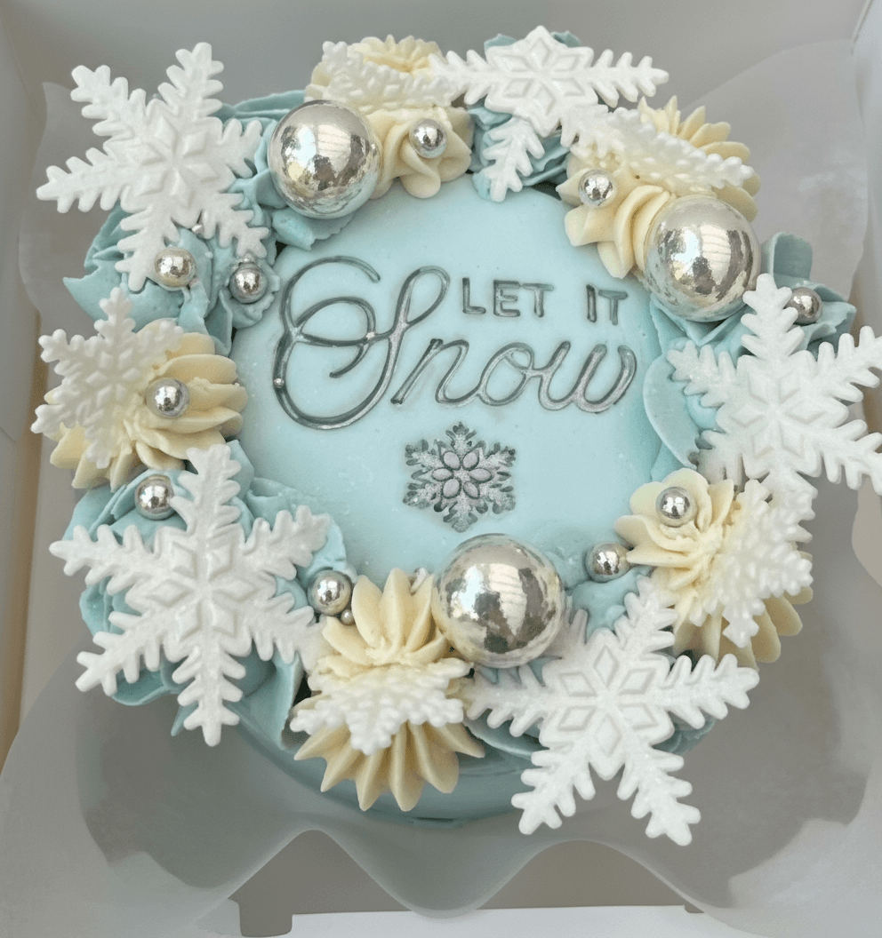 Let It Snow mini cake from the Christmas Bento Trio Class — beautifully decorated with white snowflakes, shimmer details, and buttercream piping by Sharon Burchall Cake Studio at The Hub, Clay Cross.