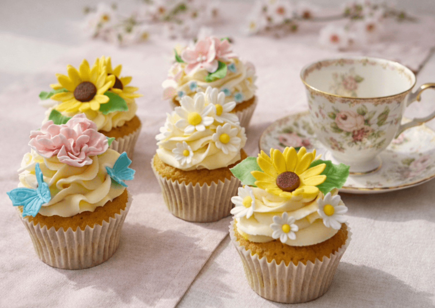 Three decorated Christmas bento cakes with buttercream and festive toppers from Sharon Burchall Cake Studio.