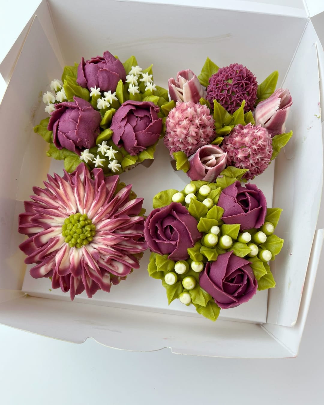 Cupcake bouquet decorated with pink buttercream flowers from Sharon Burchall’s Beginners Cupcake Bouquet Class.