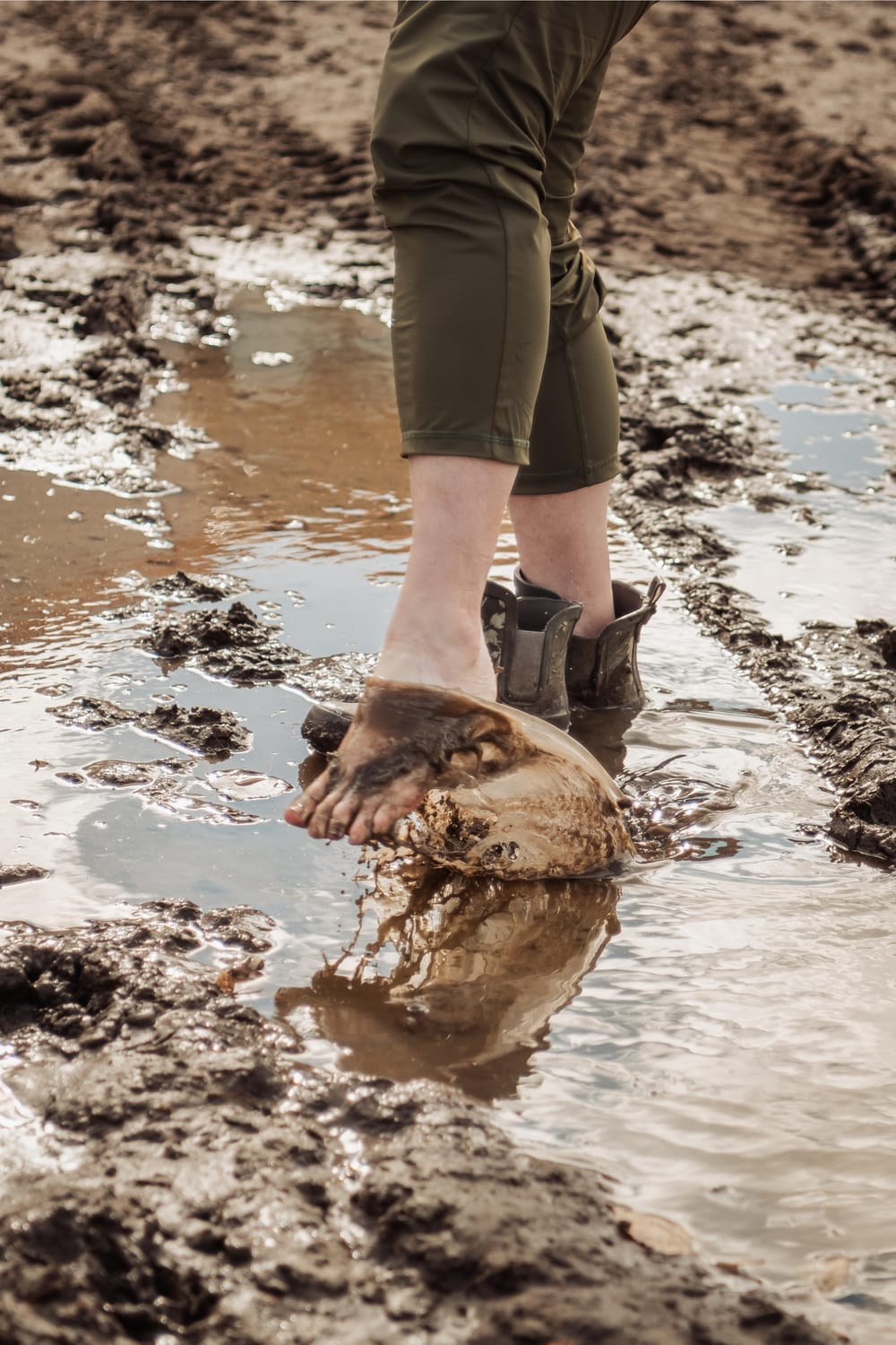 person walking in muddy water