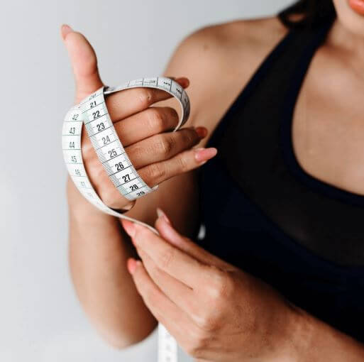 woman with measuring tape to measure fat loss and weight loss