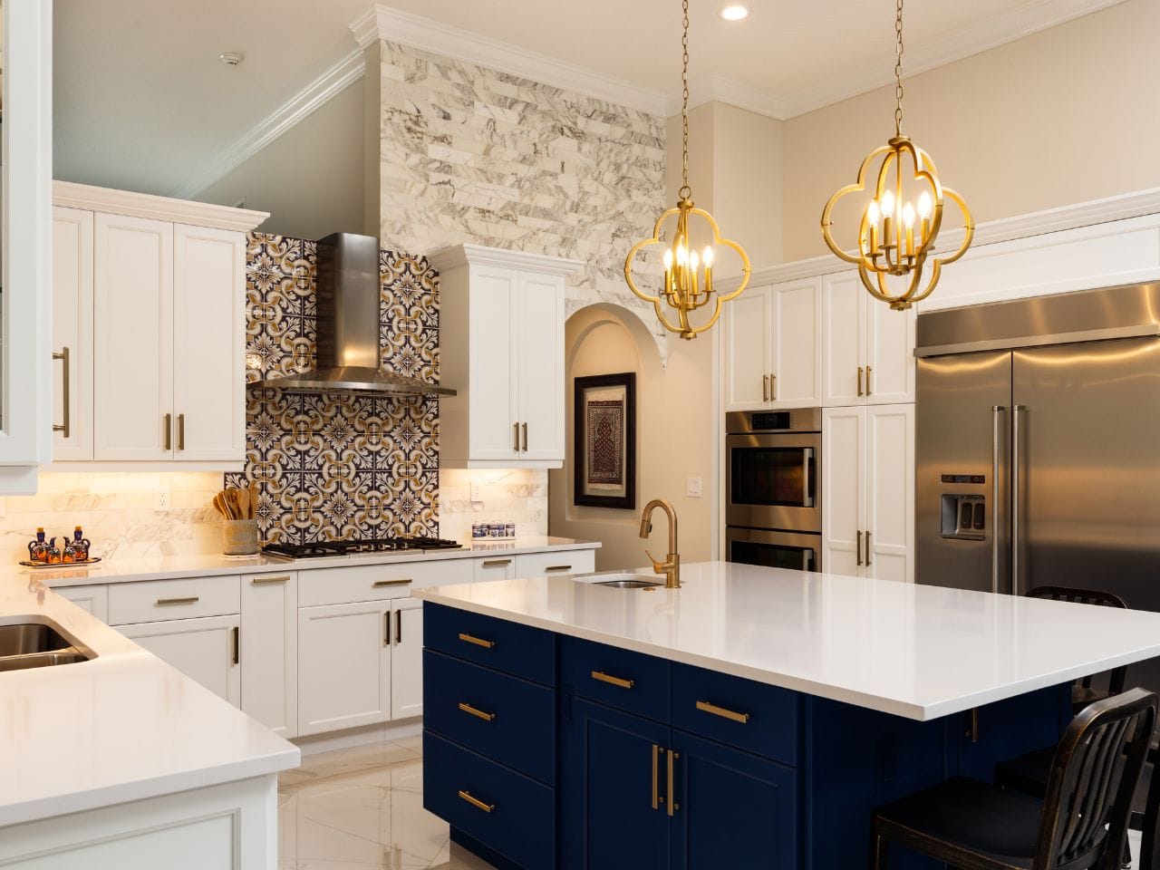 Black and white kitchen with bold tile pattern as backsplash and brass pendant lights