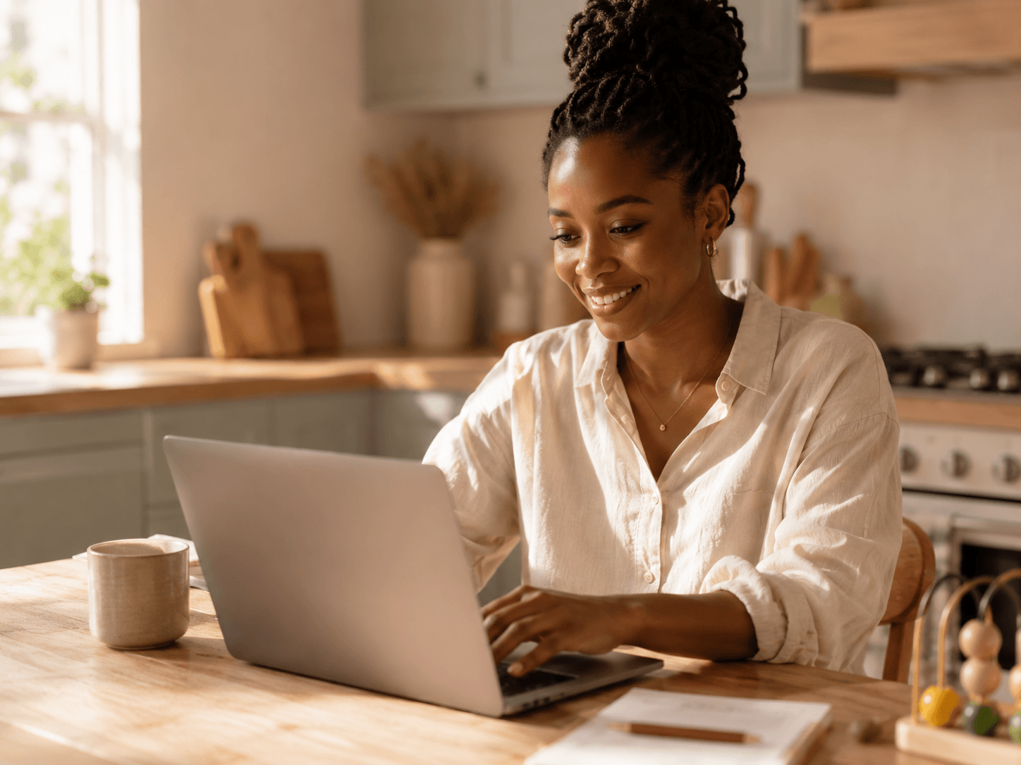 a smiling black mother sitting at a visible 