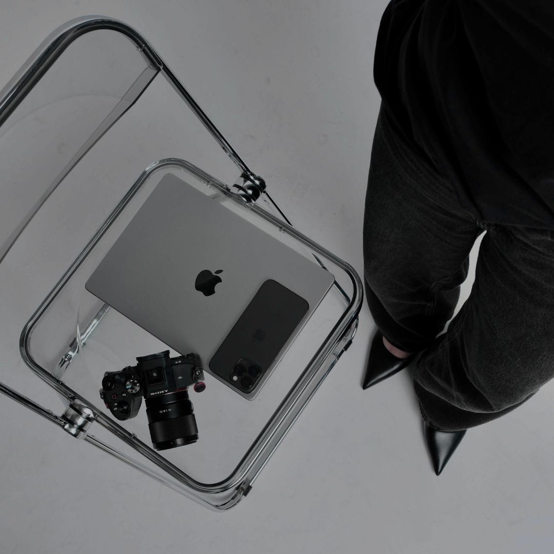 an ecommerce email marketing agency owner standing next to her laptop and email marketing mobile devices