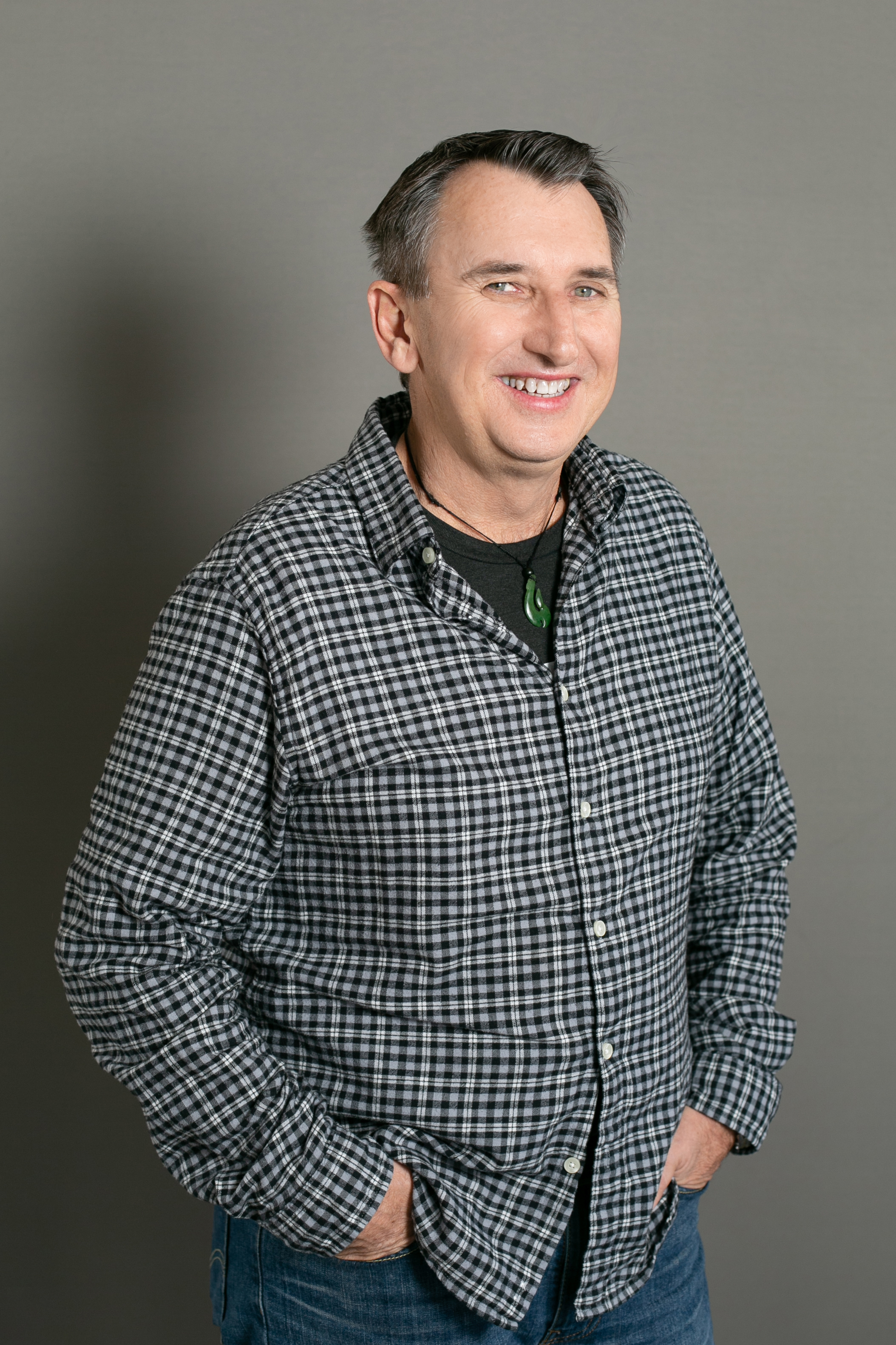 man with check shirt with grey background