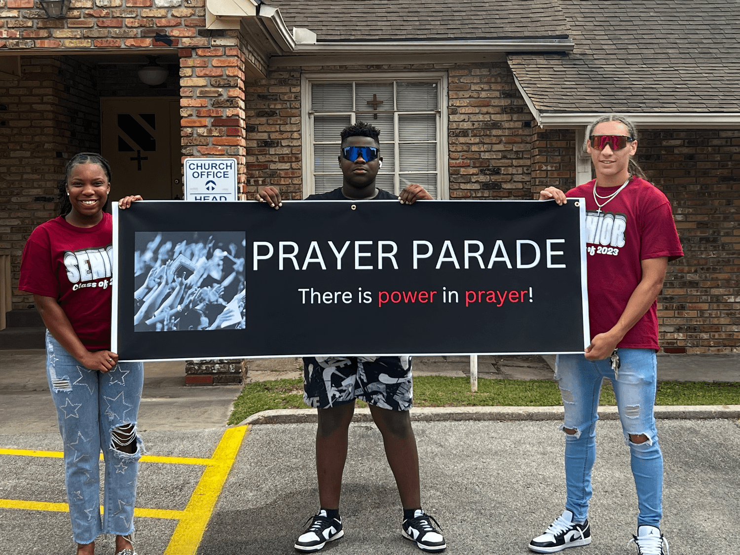 Children holding prayer parade sign