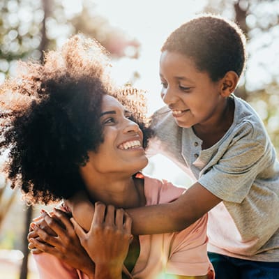 Mother and son looking at each other and smiling