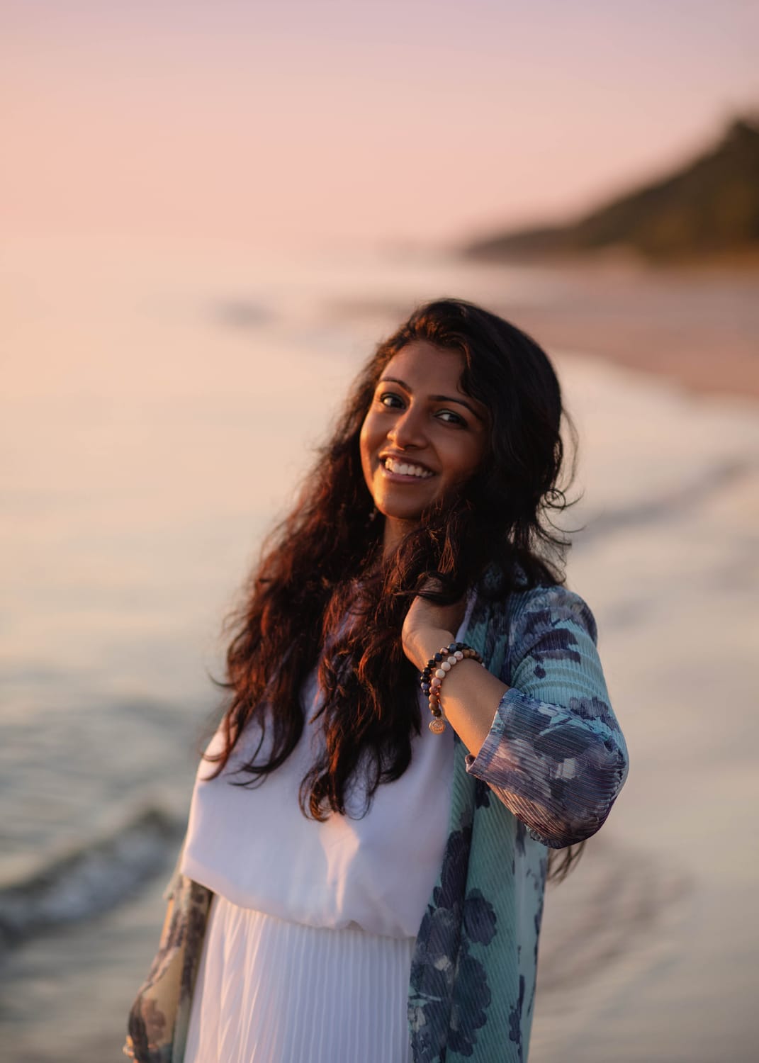 Nikhi Joshi on the beach at golden hour
