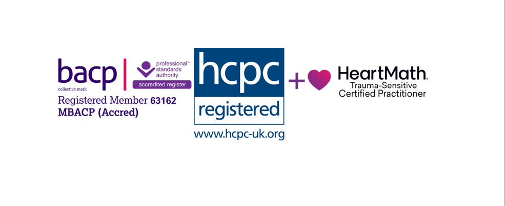 Smooth stones balanced on top of one another within blue water. The stones reflect in the water, with a slight ripple around the stones.