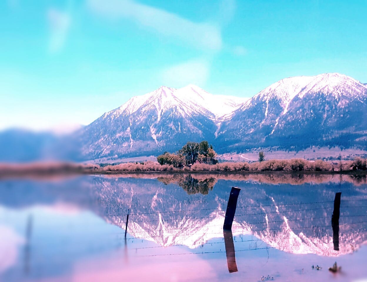 Snow-capped Sierra Nevada mountains reflecting in still waters at sunset in Carson Valley, Nevada—an awe-inspiring landscape ideal for bespoke travel planning, luxury adventure itineraries, and soulful journeys curated by a boutique travel consultant.