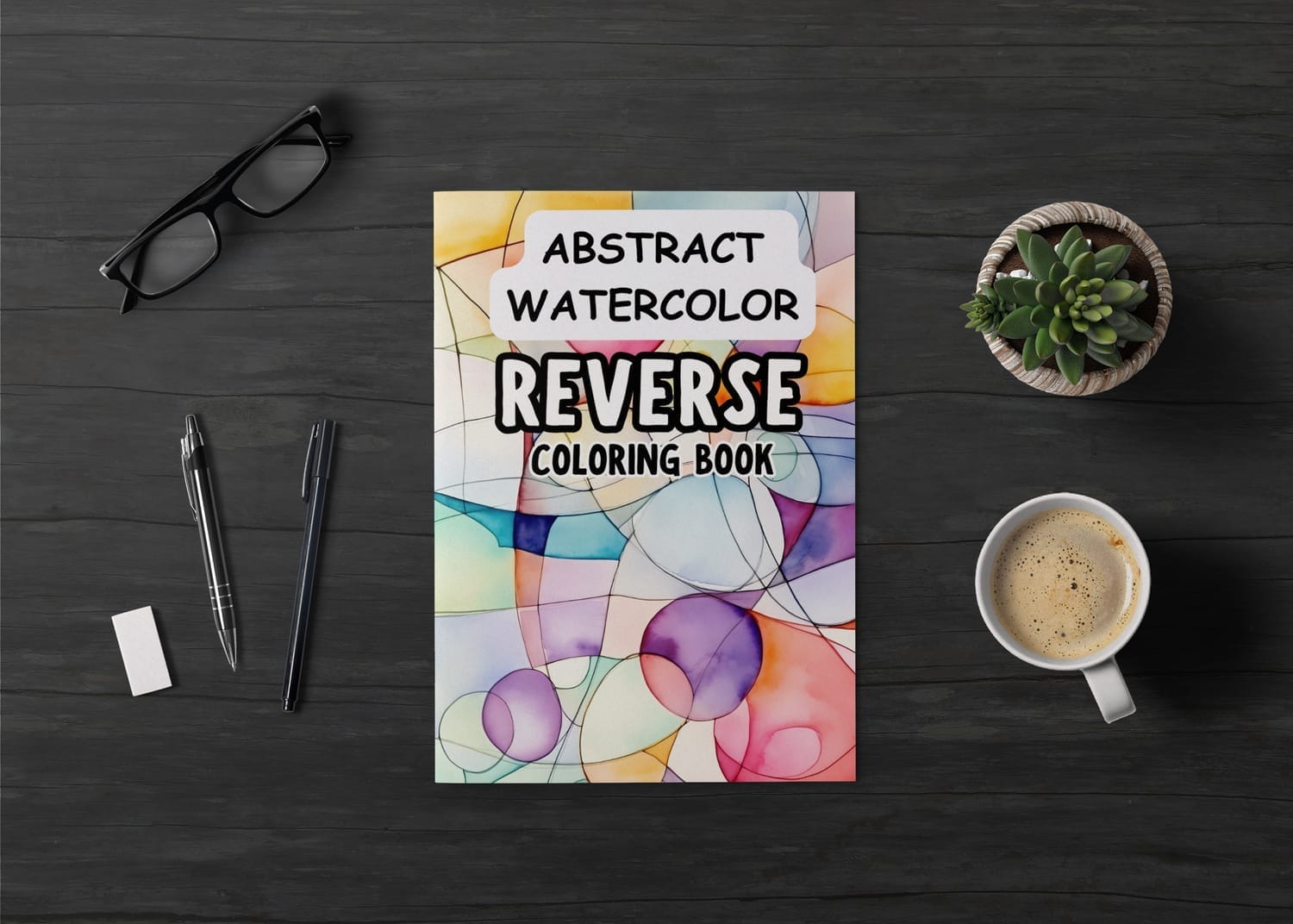 Abstract watercolor reverse coloring book on a desk with pens, coffee, glasses, and a plant, featuring colorful organic shapes and text promoting creativity and calm.