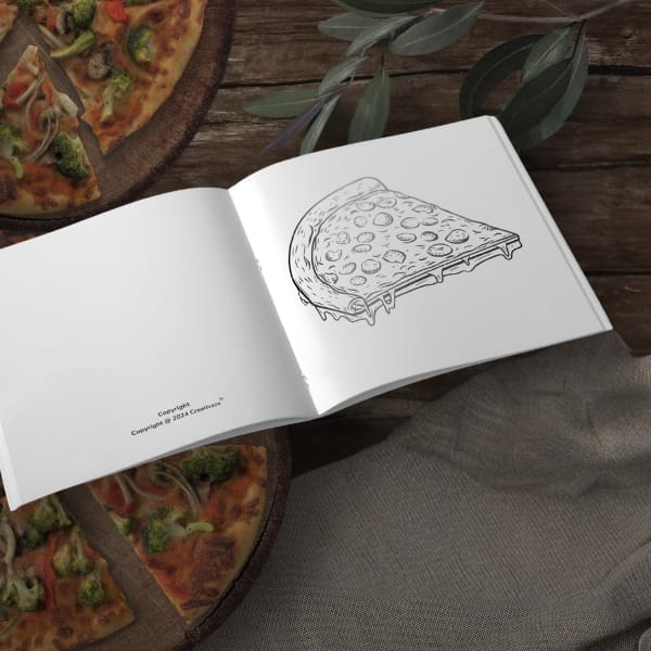 Open coloring book with a cheesy pizza slice line drawing on a rustic wood table, with a real veggie pizza in the background.