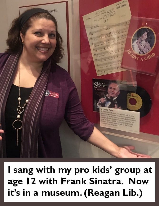 Malayna poses with the Frank Sinatra single she sang on with her children's group on display at the Reagan Library