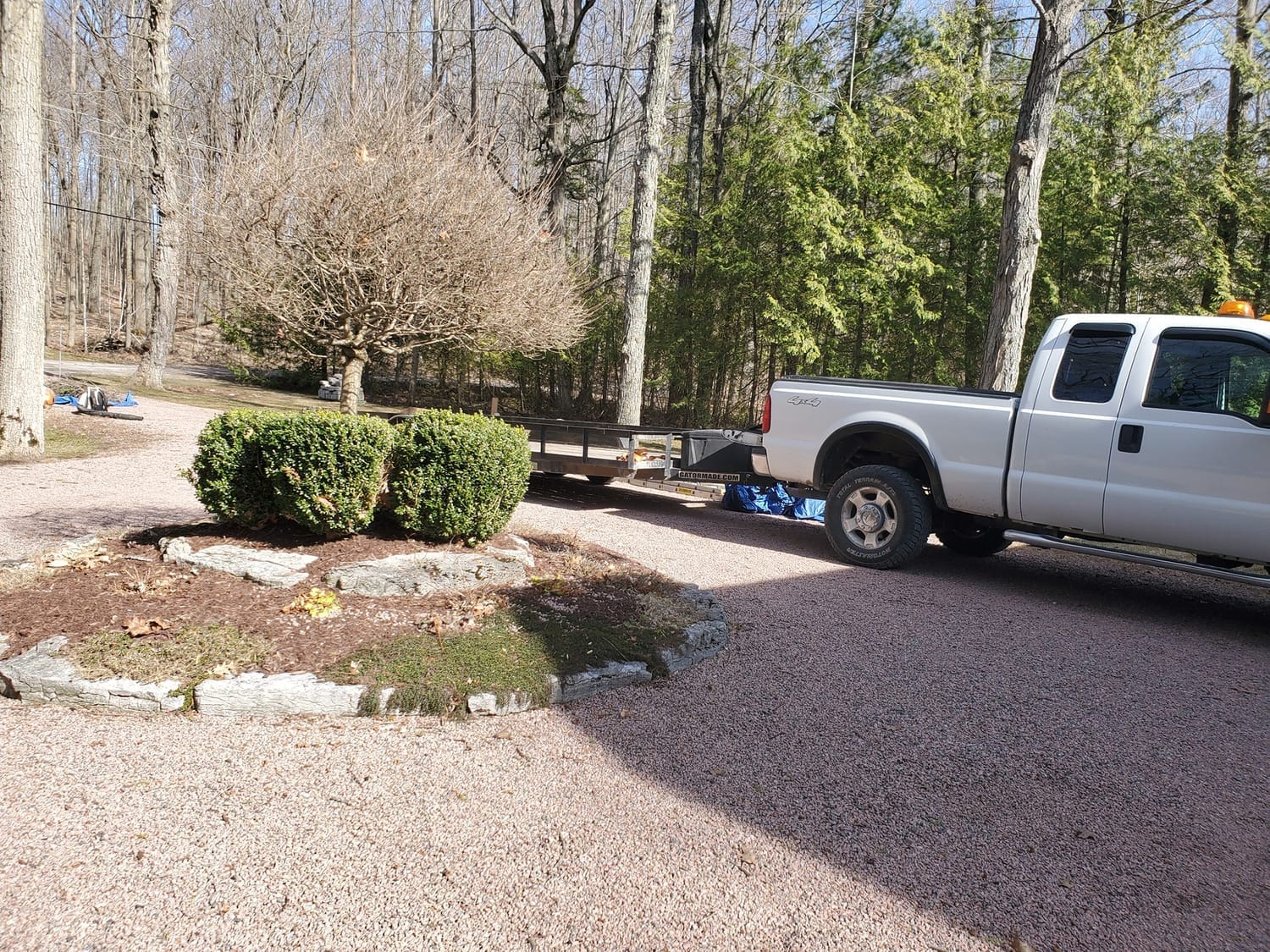 Image: Property maintenance truck in a driveway during seasonal maintenance (spring/fall)