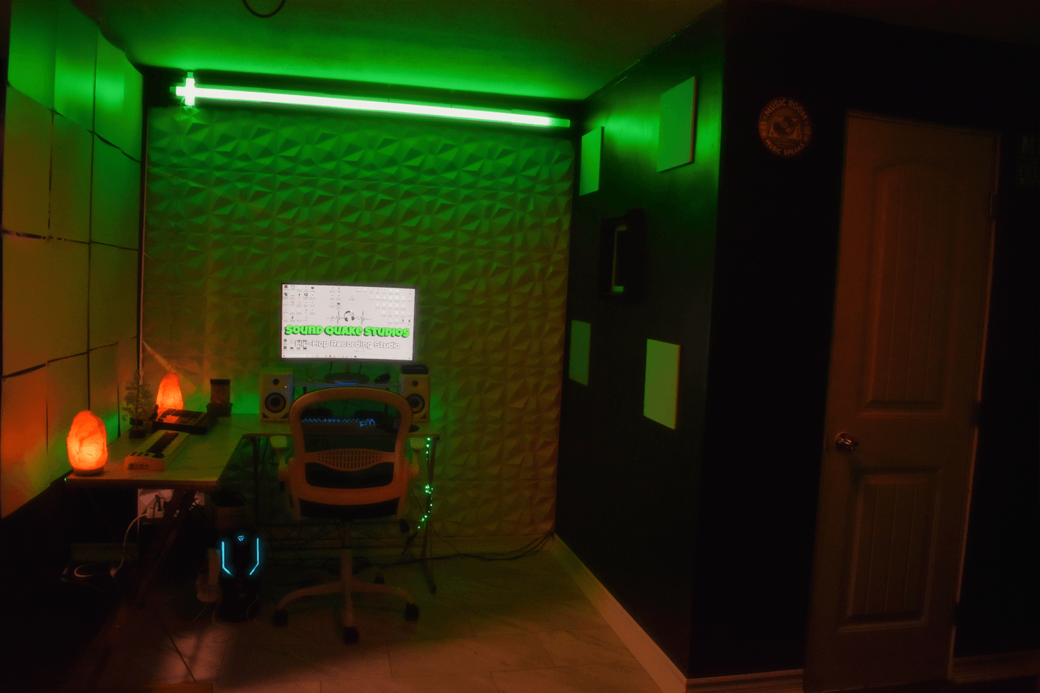 Music production setup with computer, mixing equipment, and monitors at Sound Quake Studios Cape Breton