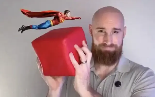 From the course: Eric holding a red cube while a tiny cartoon superhero flies past