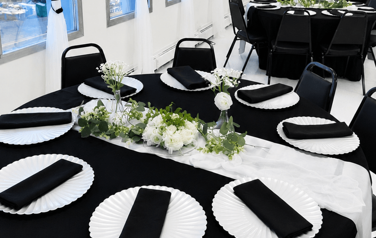Upscale Elevated Event Package with black tablecloths and black banquet chairs set up at TD Event Space in Denver