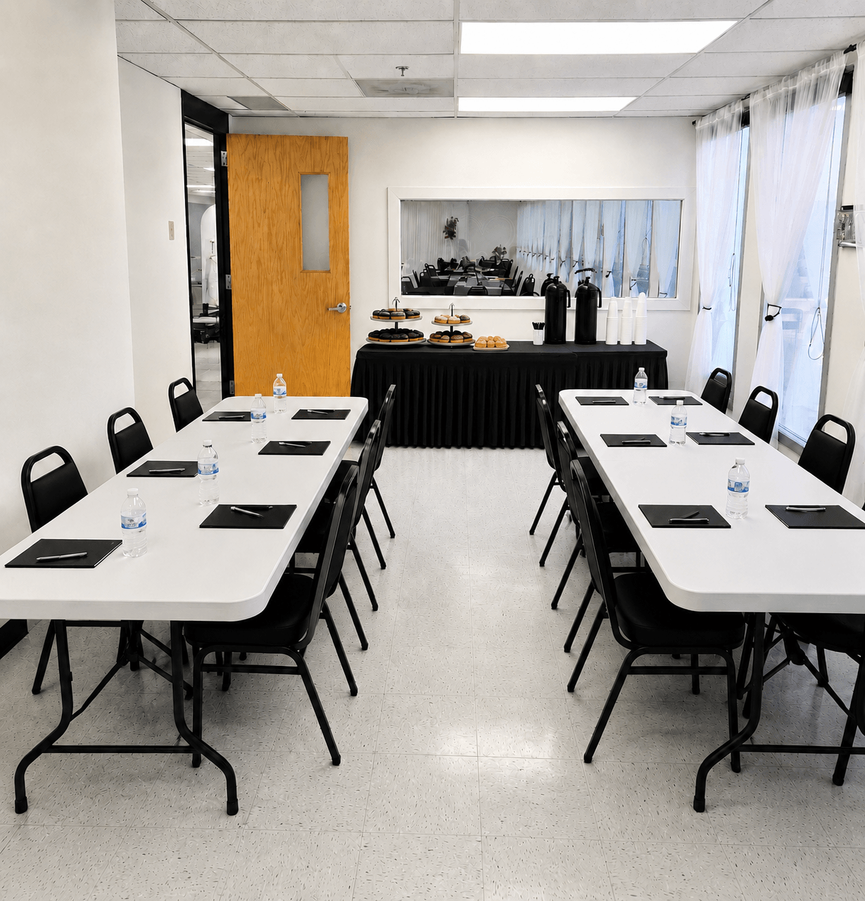 corporate meeting set up in the small room at TD Event space with rectangular tables