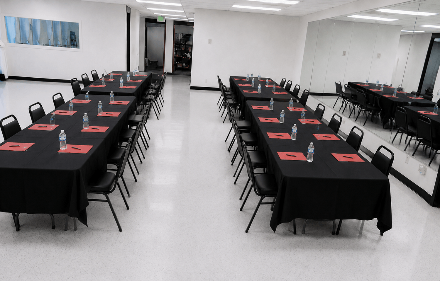 corporate meeting event set up in the large area at TD Event Space with black tablecloths