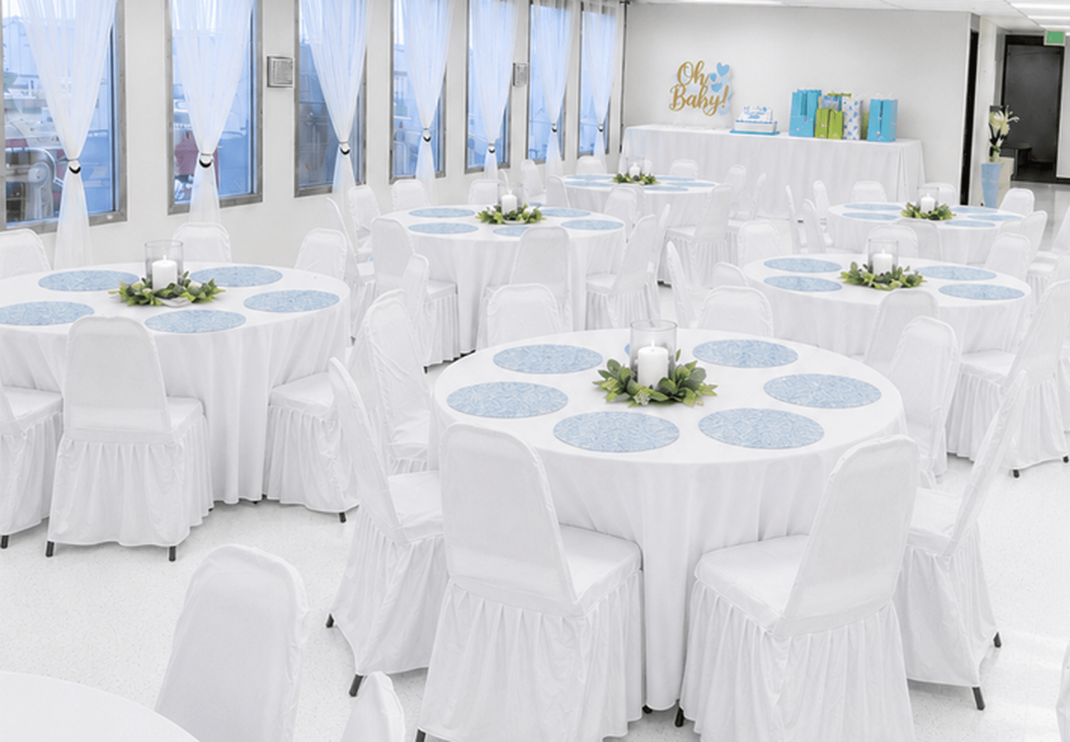 beautiful baby shower set up with white tablecloths and chair covers at TD Event Space