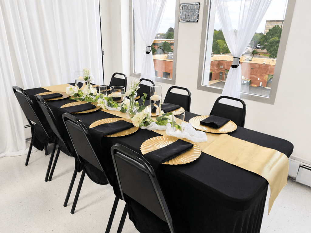 Black and gold elegant tablescape by windows