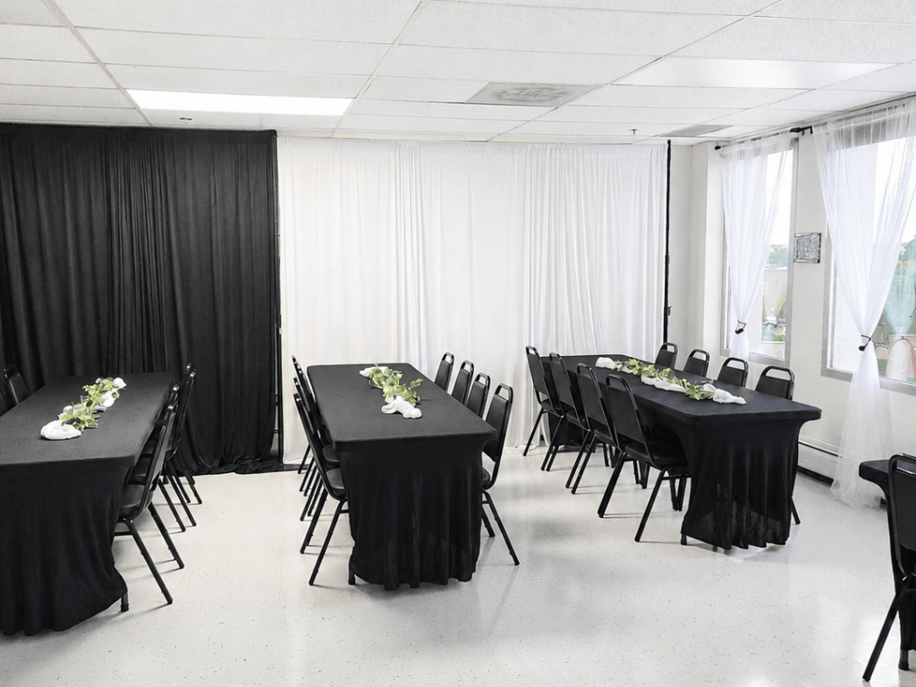 Black banquet tables with elegant greenery decor