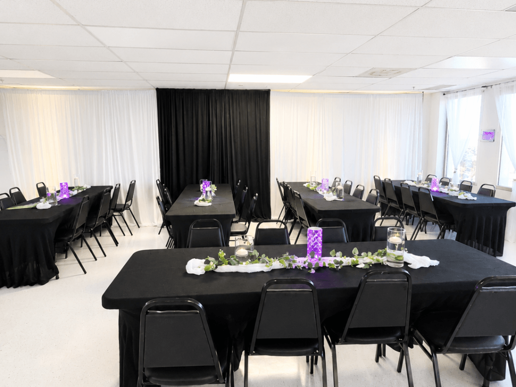 Black banquet tables with elegant purple centerpieces