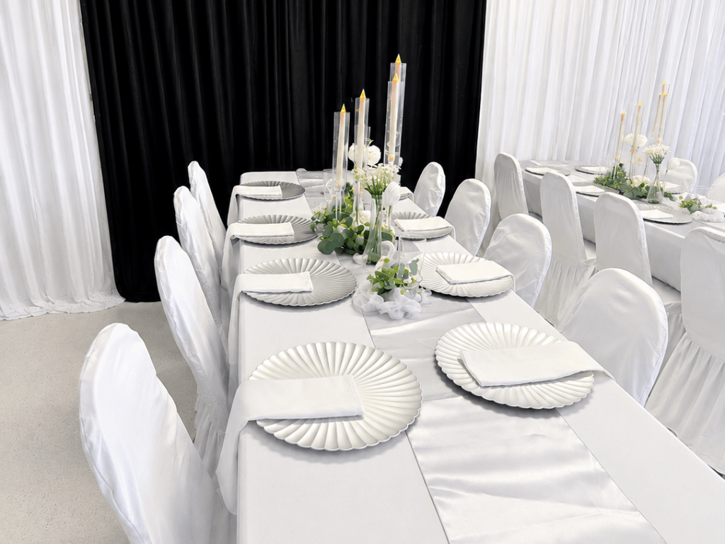 Elegant white tablescape with candle centerpiece