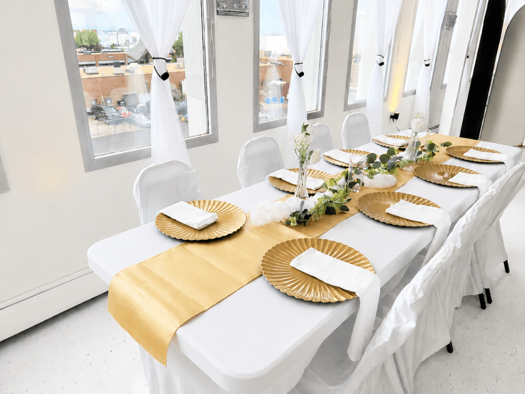 Elevated Event Package White and gold tablescape by large windows
