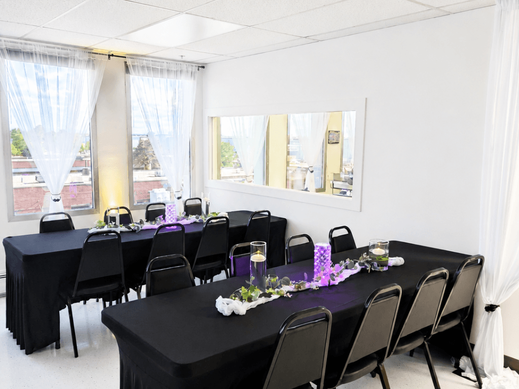 Event tables with purple centerpieces and windows