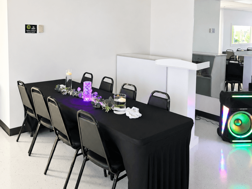 Head table with purple centerpiece and podium