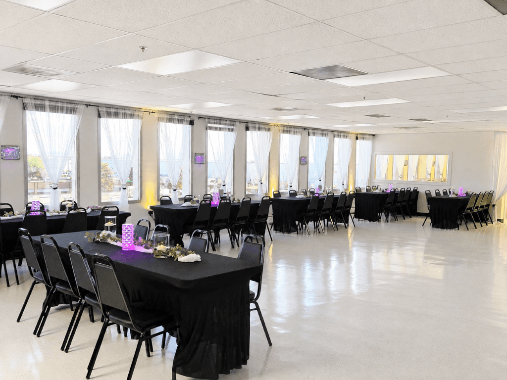 Black and purple reception venue setup with dance floor area