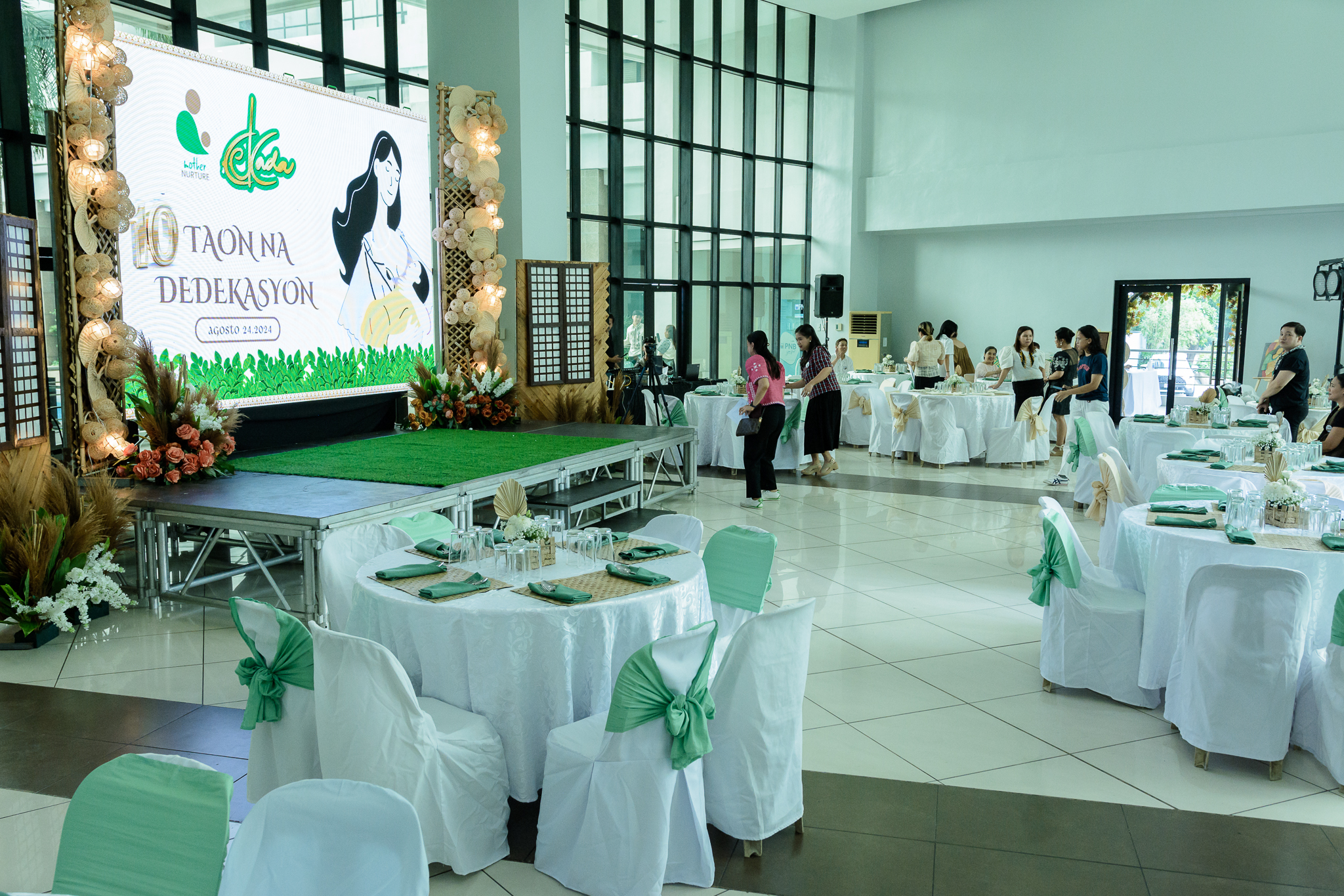 HD photo of the stage with tables and chair arrangements in celebration of the 10th year anniversary of a company