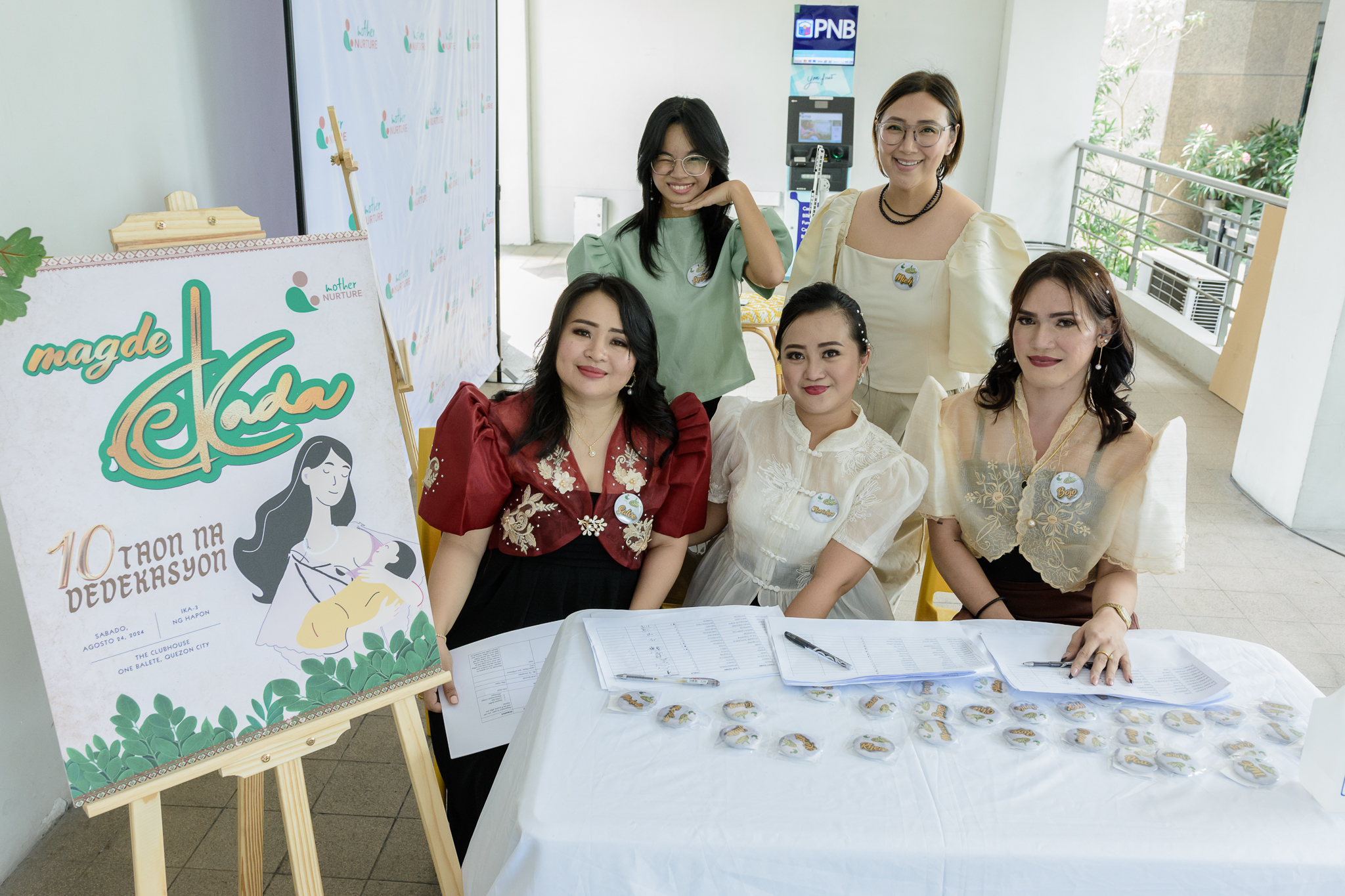 photo of the registration booth where the staff wears modern barot saya in celebration of the 10th year company anniversary